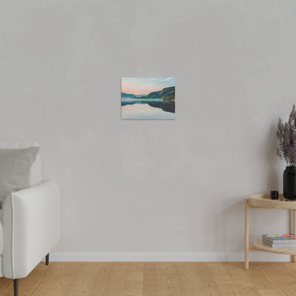 Small square landscape canvas of a lake and mountains hangs on a light gray textured wall in a minimalist living room.
