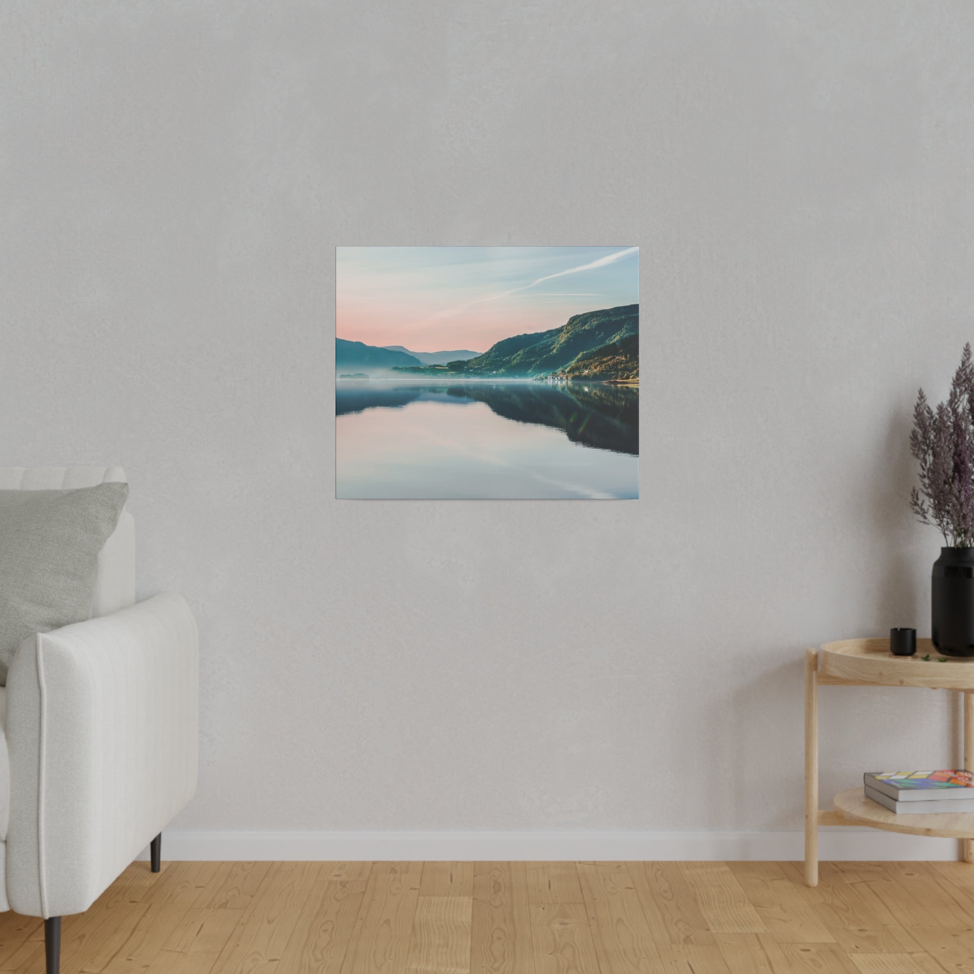 Small square wall art of a tranquil lake and mountains at sunset, hung on a light gray wall.
