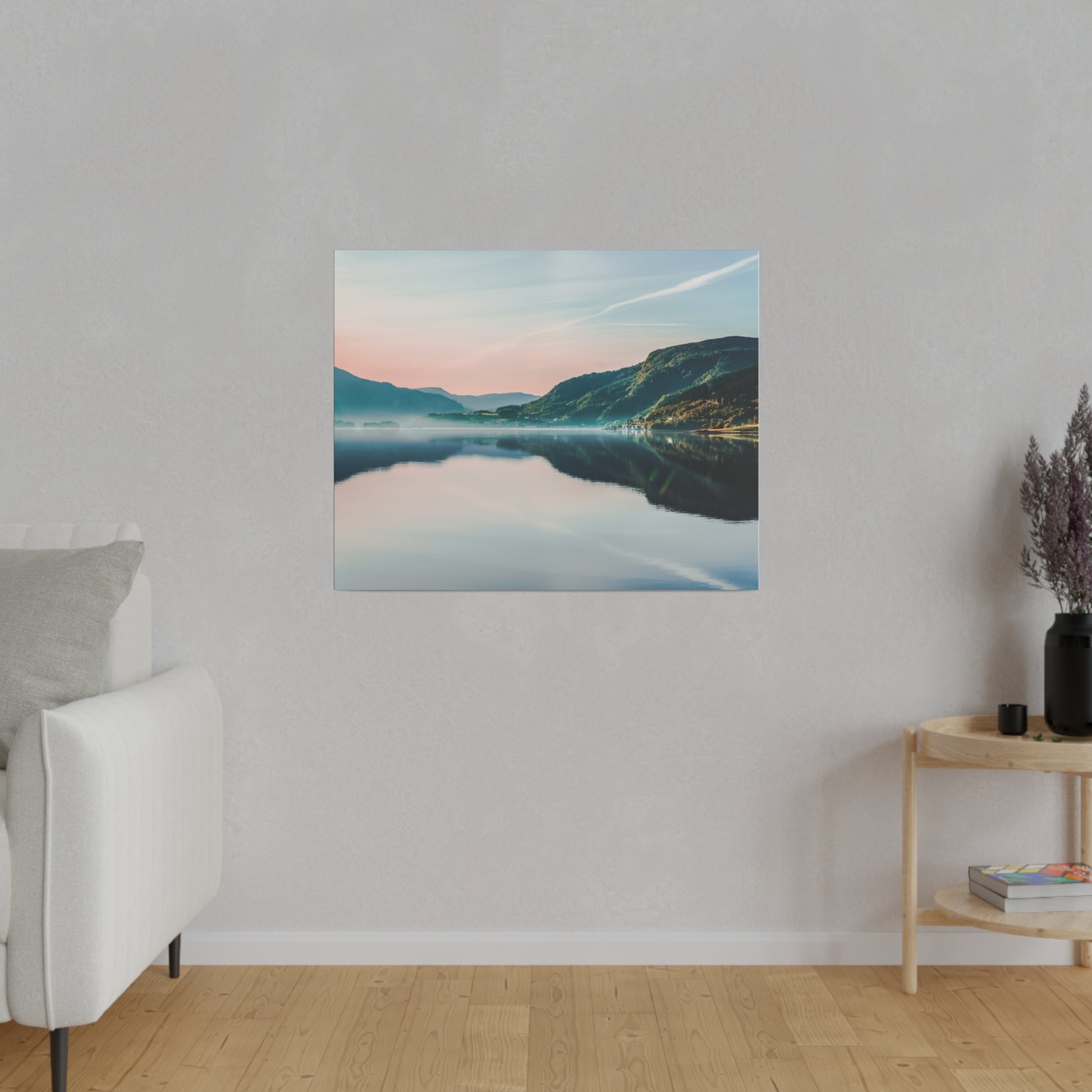 Square wall art depicting a calm lake reflecting mountains at sunset with pastel pink and blue skies.