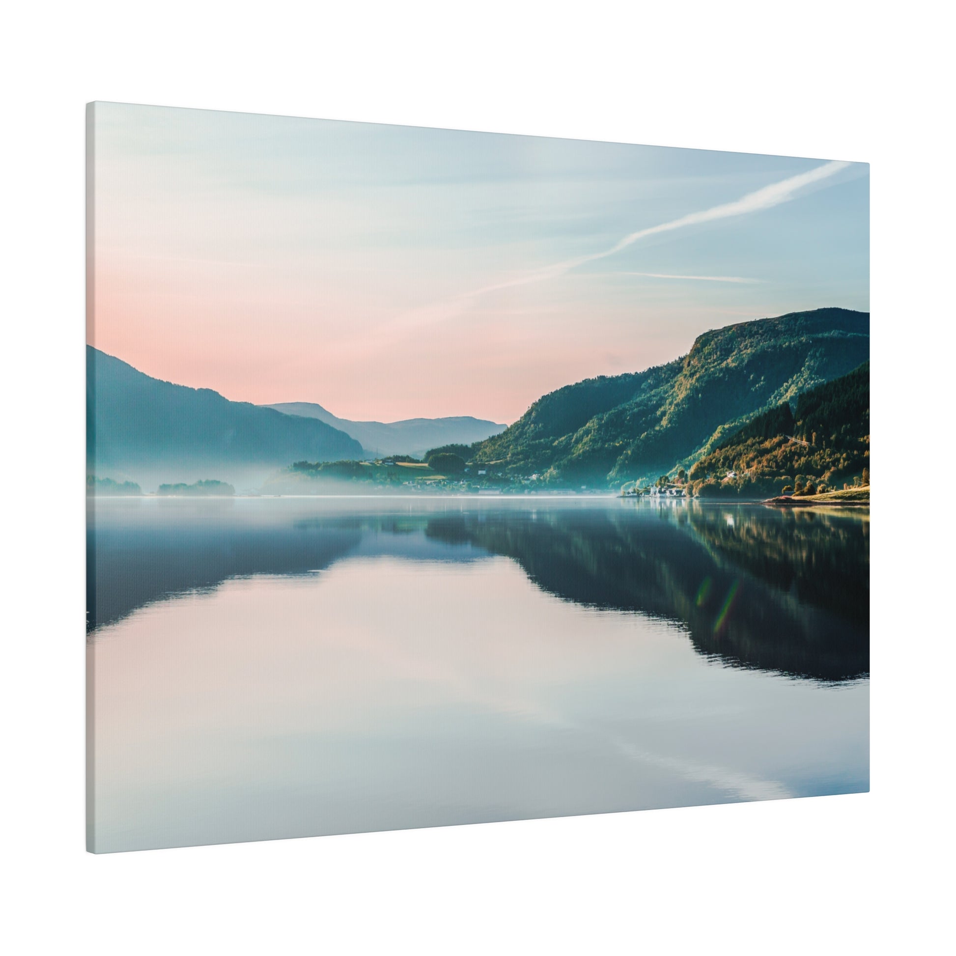 Landscape photograph of a calm lake reflecting mountains and a pastel sky at dawn, with mist along the shoreline.