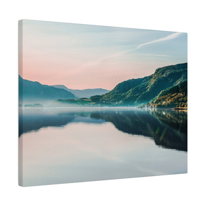 Canvas print of a tranquil mountain lake at dusk with pink sky, green hills, and a clear reflection on the water.