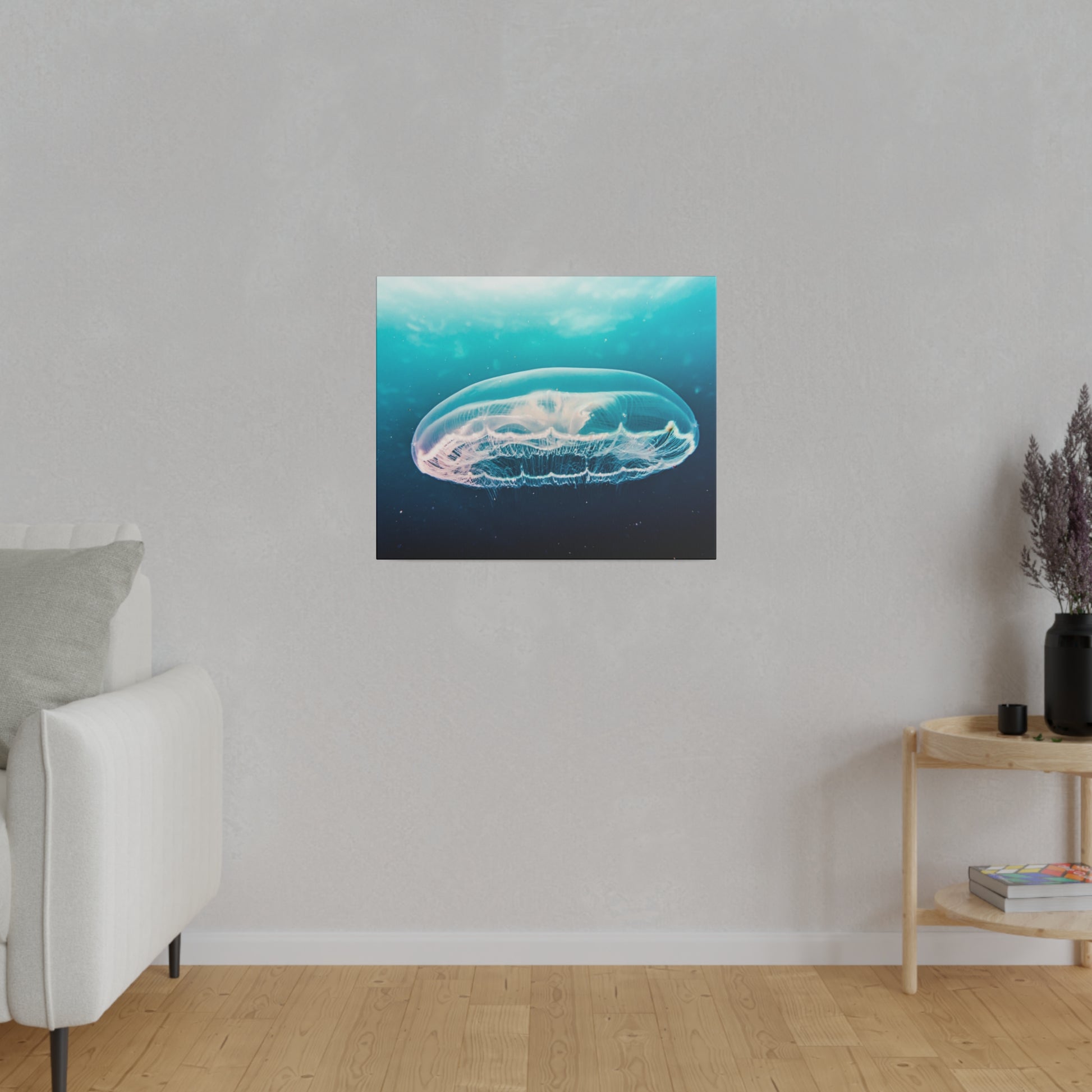 Square wall art showing a translucent blue jellyfish underwater, mounted on a light gray textured wall.
