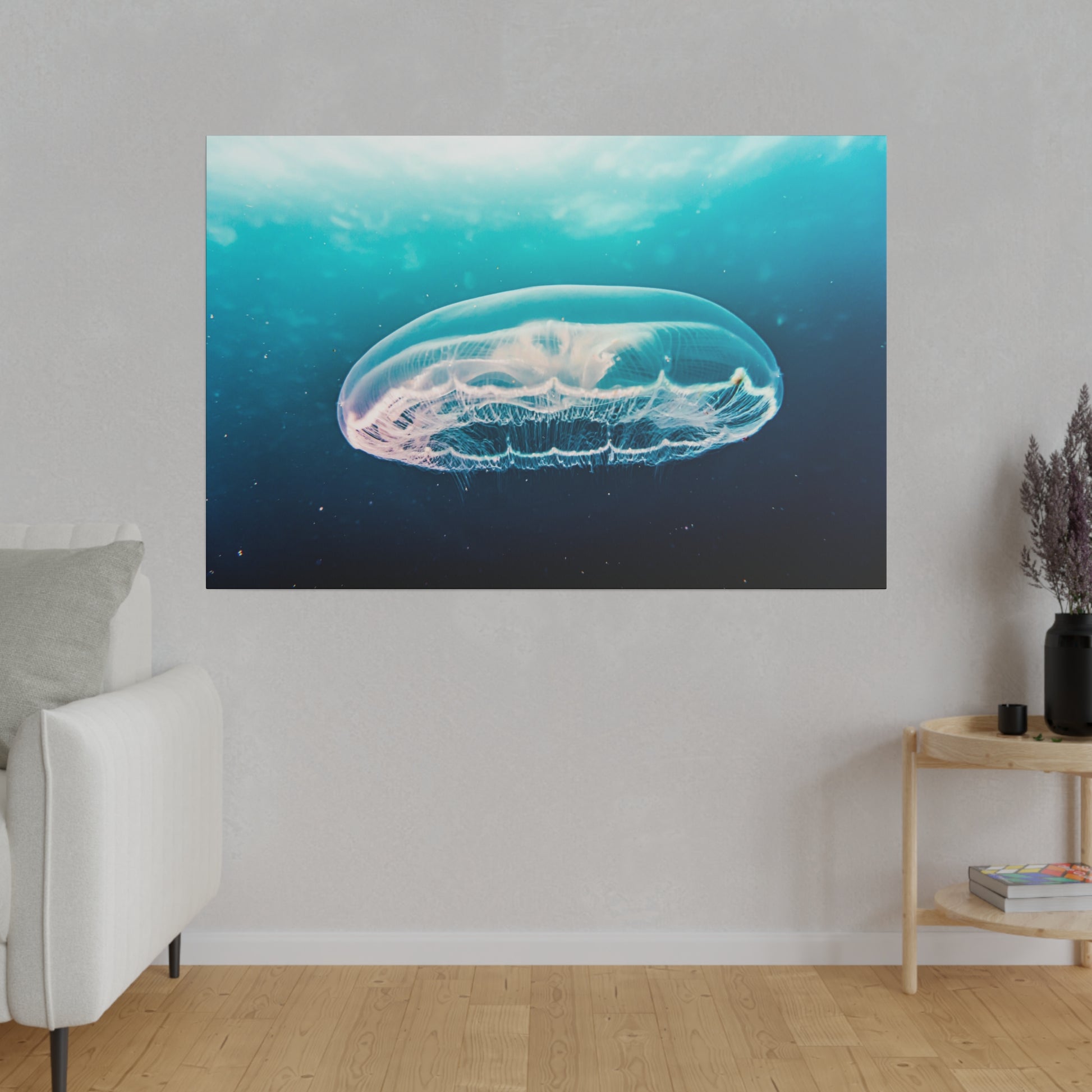 Framed wall art showing a translucent jellyfish suspended in blue ocean water.