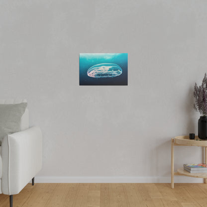 Small wall art print of a blue jellyfish underwater, centered on a light gray wall above a wooden floor.