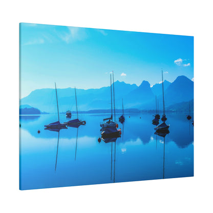 Blue-toned canvas of sailboats anchored on a tranquil harbor with distant blue mountains reflected in the water.
