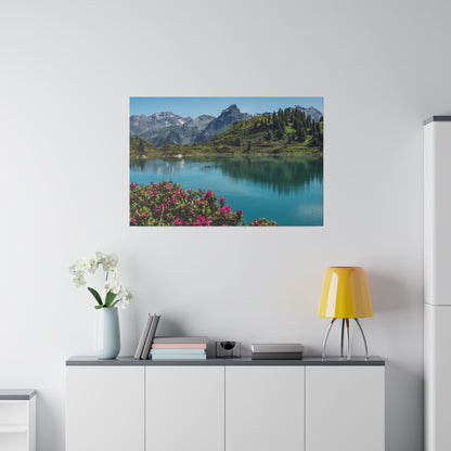 Wall-mounted landscape photograph of a turquoise lake with mountains and pink flowers in the foreground.