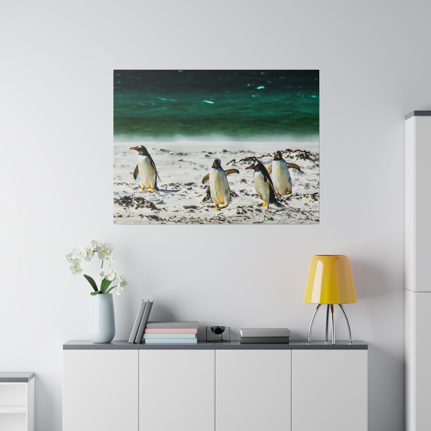 Penguins on a sandy shoreline, with the ocean waves in the background. The tranquil seascape showcases these seabirds in their natural habitat.