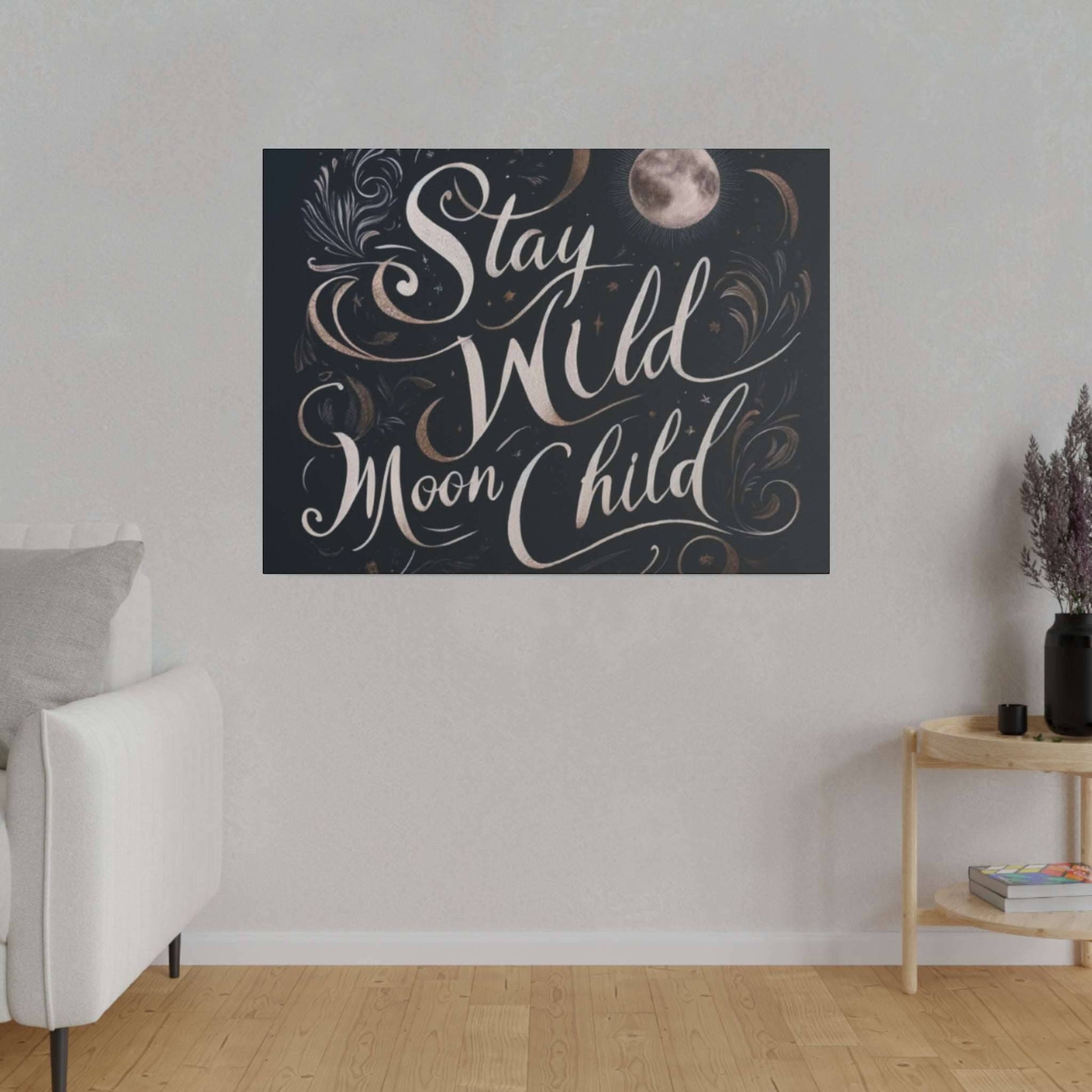 Dark navy canvas print with white cursive text “Stay Wild Moon Child” and decorative moons and swirls.