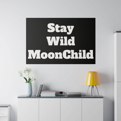 Black wall poster above a cabinet with bold white text: Stay Wild MoonChild.