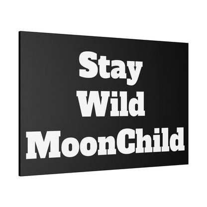 Black wall art canvas with large white bold text reading 'Stay Wild MoonChild' across three lines.