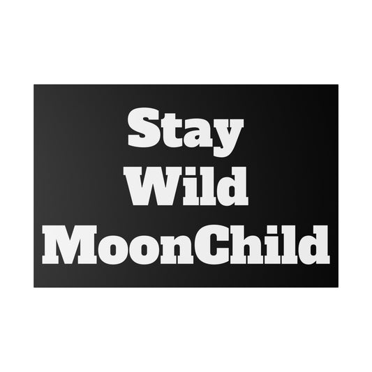 Black rectangular sign with large white bold text reading “Stay Wild MoonChild.”