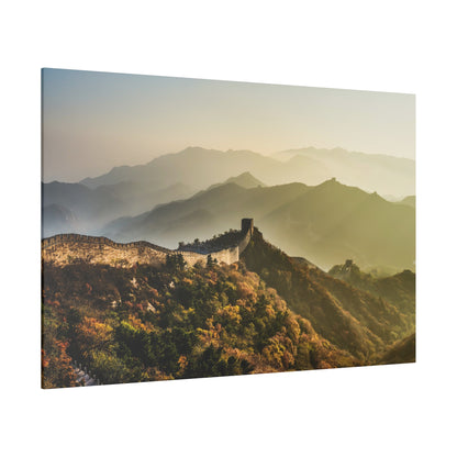 A section of the Great Wall winds over autumn-colored mountains with misty layers in the distance.