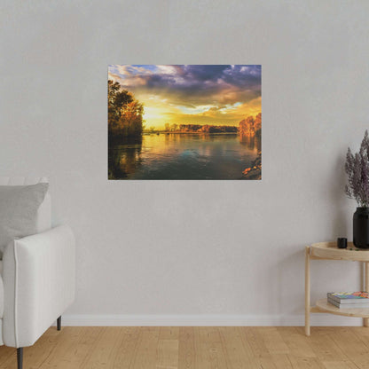 Framed landscape photo of a calm river at sunset, with orange and yellow skies and trees along the banks.