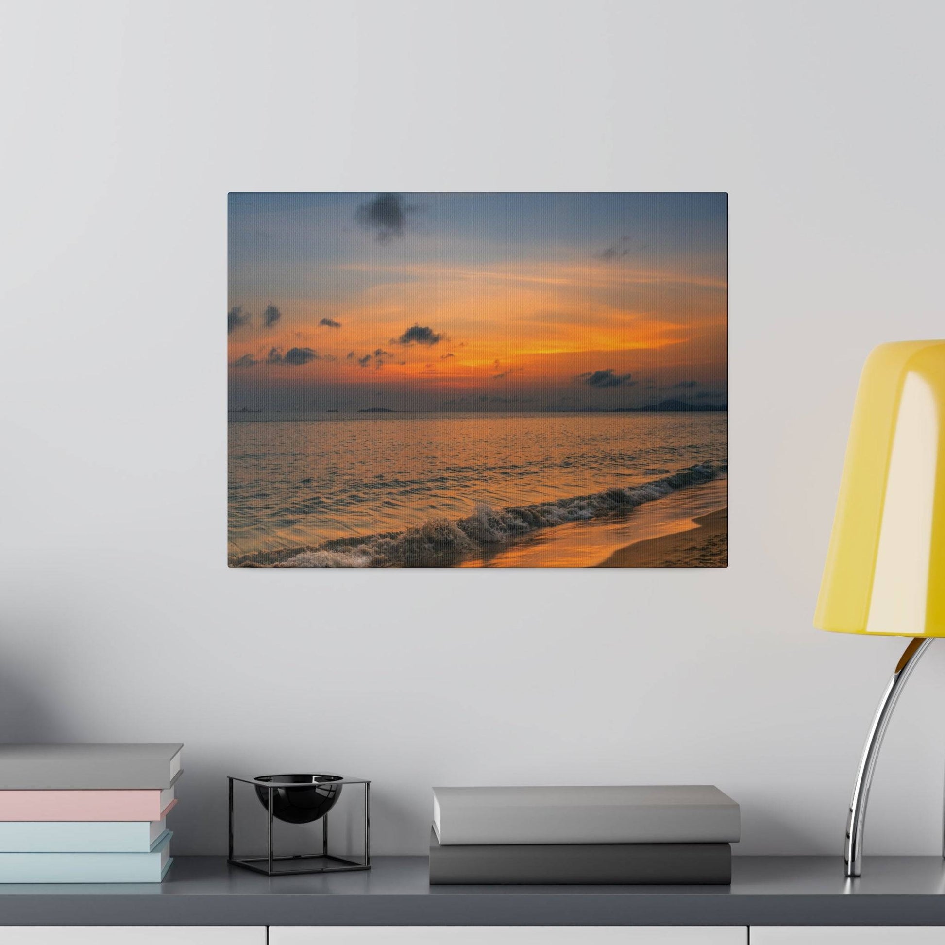 Square canvas print of a sunset over the ocean, with orange and blue sky and waves.
