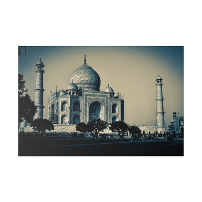 Blue-toned photograph of the Taj Mahal showing its central dome, white marble facade, and surrounding minarets with trees and visitors in