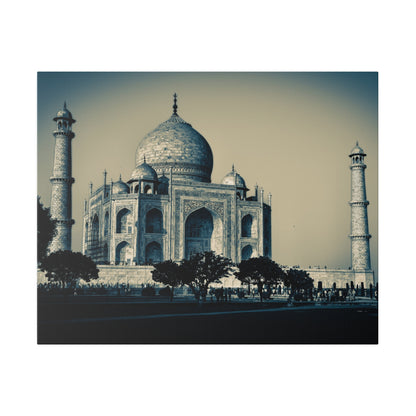 Blue-tinted photo of the Taj Mahal with its central dome, arches, and minarets, seen from the foreground with trees and visitors.