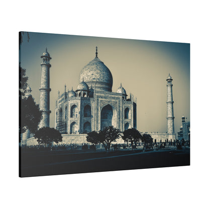 Taj Mahal in white marble with a central dome and four surrounding minarets, seen with trees and visitors nearby.