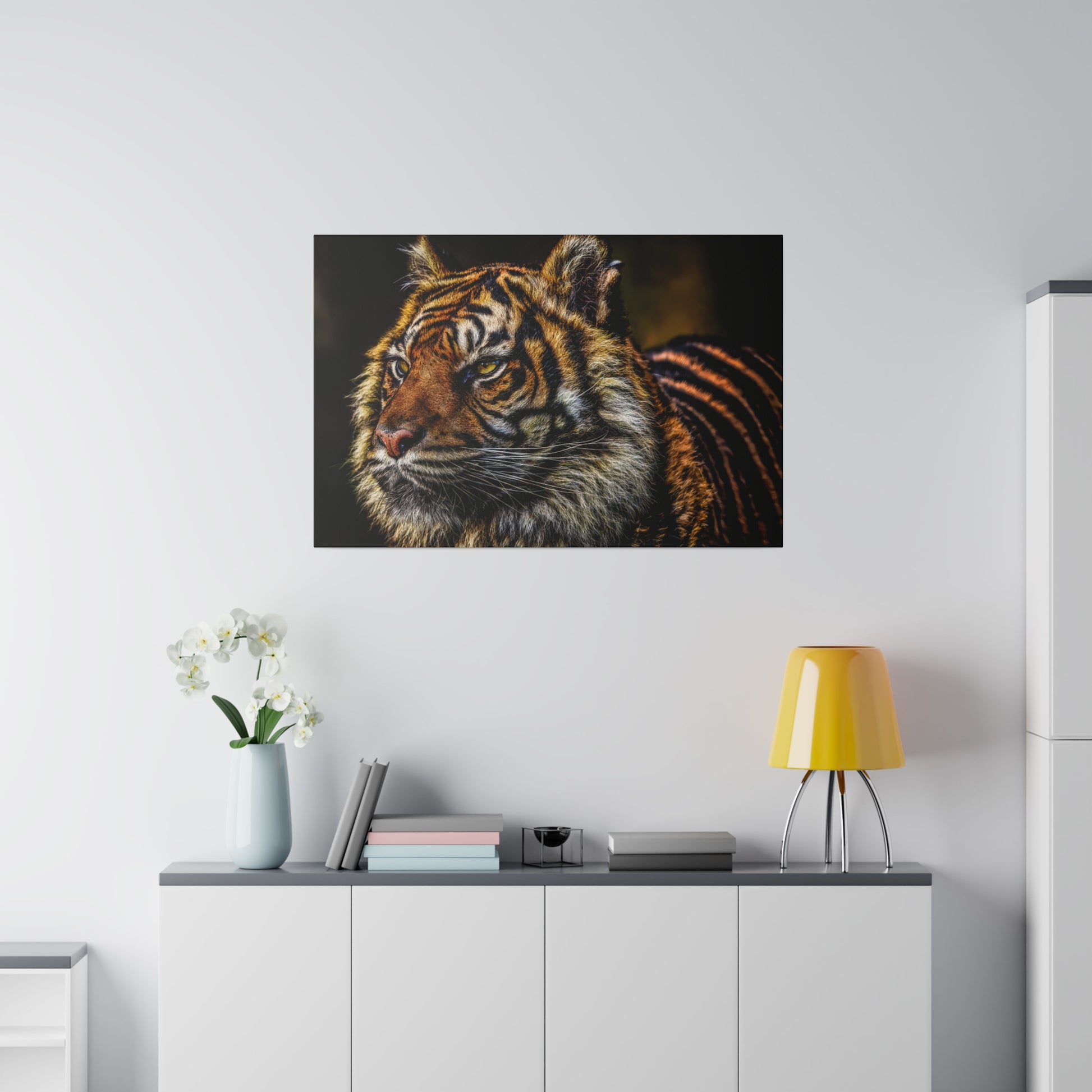 A focused close-up of a tiger, showcasing its intense eyes and detailed facial features. The portrait highlights the majestic and powerful nature of the tiger.