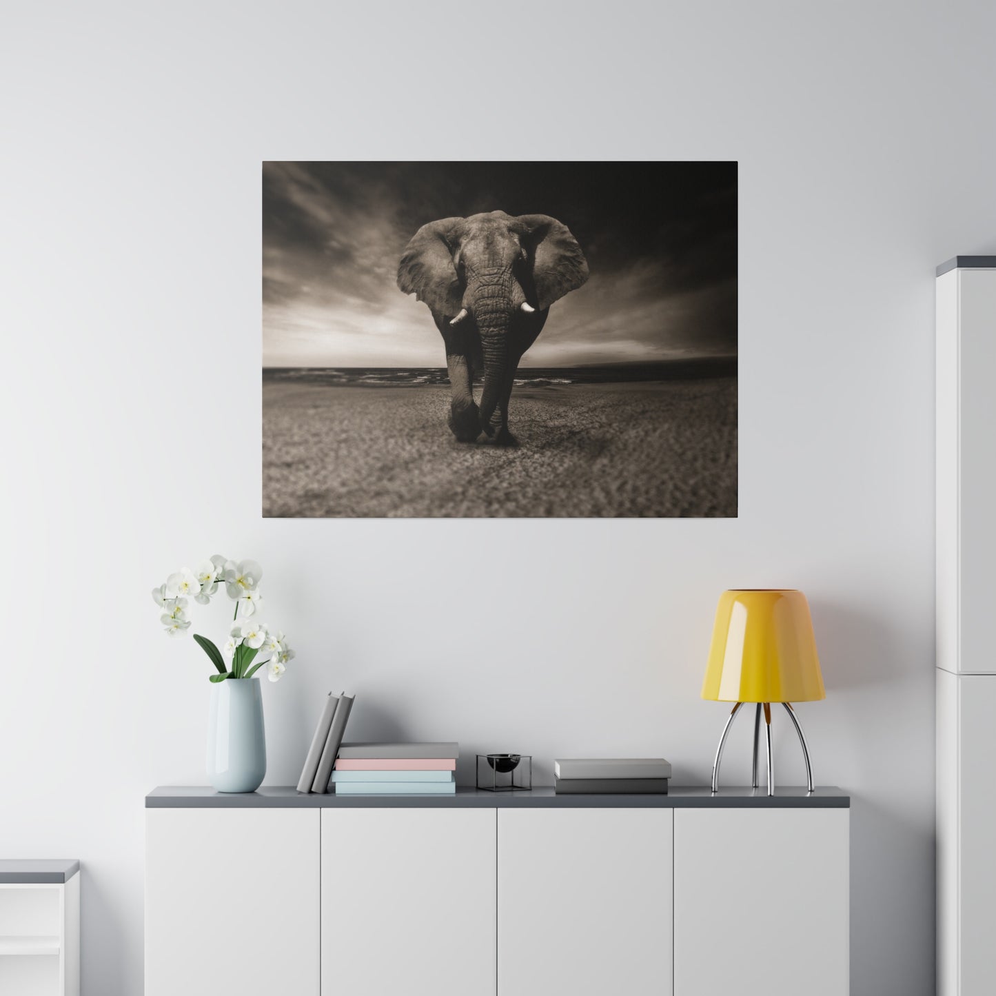 A tranquil scene of an elephant on the coast, captured in black and white, emphasizing the calm and majestic presence of the animal.