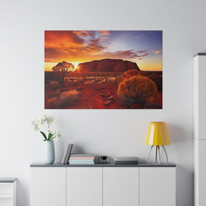 Large wall art depicting Uluru at sunset over a red desert, hung above a white sideboard with a yellow lamp.