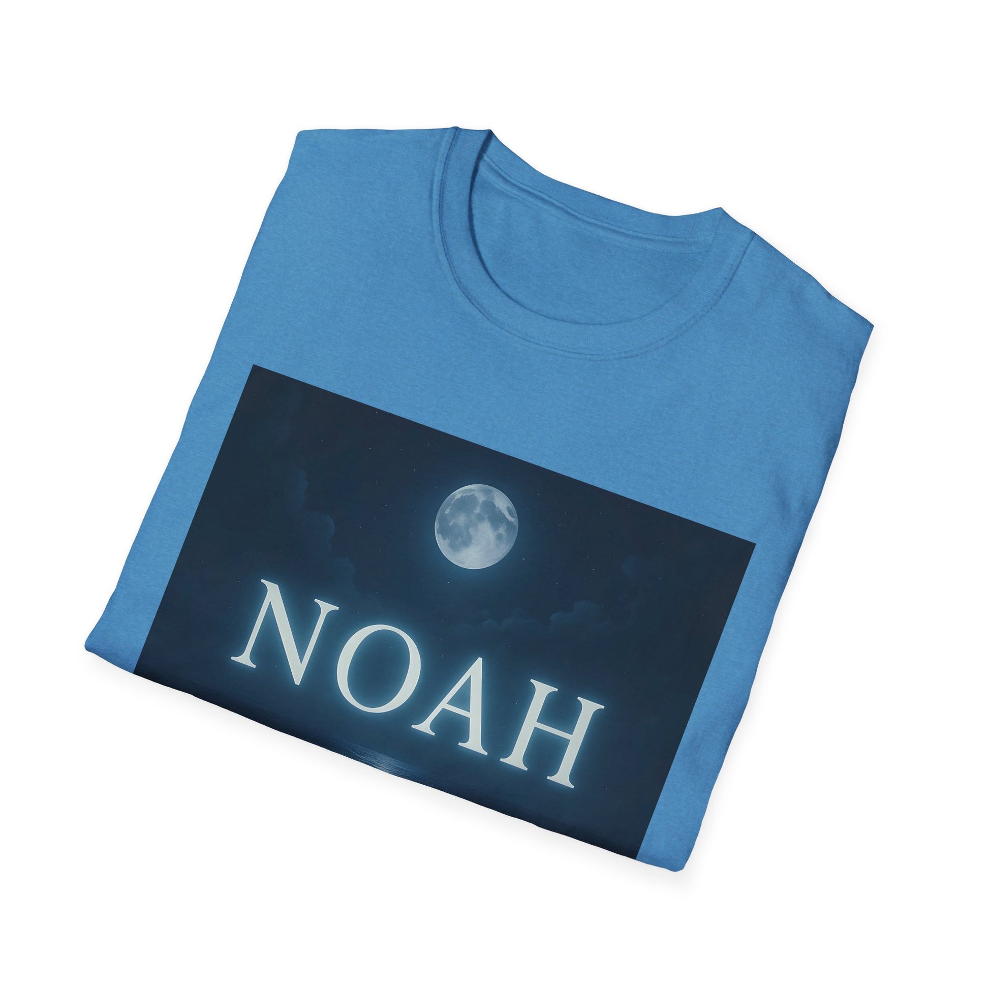 Blue t-shirt folded with a dark rectangular graphic showing a full moon and the name NOAH in white letters.