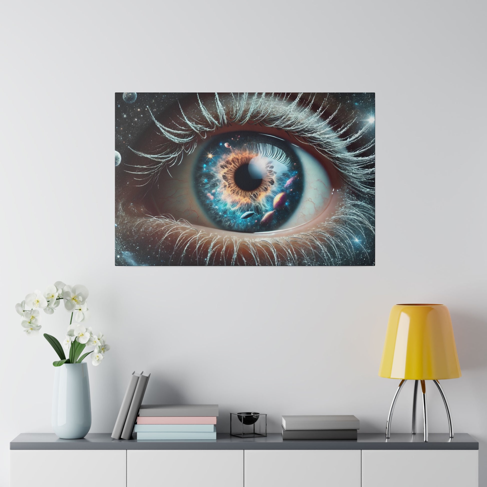 Close-up of a blue eye with space-themed colors and stars around the iris, mounted on a white wall.