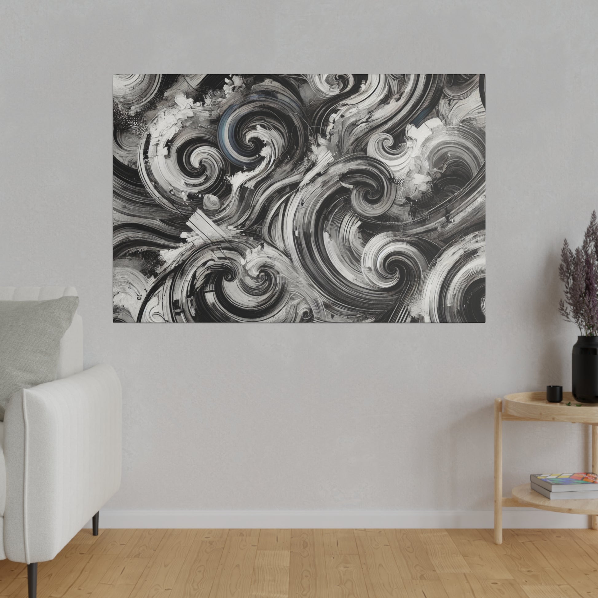 Abstract black-and-white swirl painting mounted on a light gray living room wall above a wooden floor.