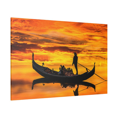 Silhouette of a gondola with people and a standing gondolier against an orange sunset, reflected on calm water.