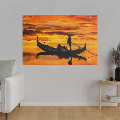 Wall art showing a black gondola with passengers and a gondolier on bright orange sunset water.