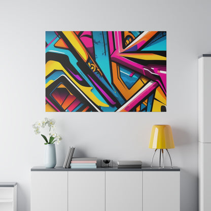 Colorful abstract graffiti art mounted on a light gray wall above a white console with books, a vase, and a yellow lamp.