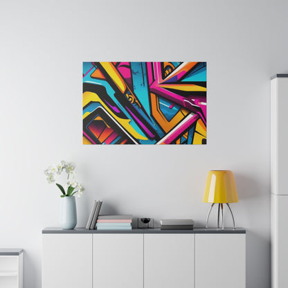 Colorful abstract graffiti art canvas mounted on a white wall above a cabinet with a yellow table lamp and a vase of white orchids.