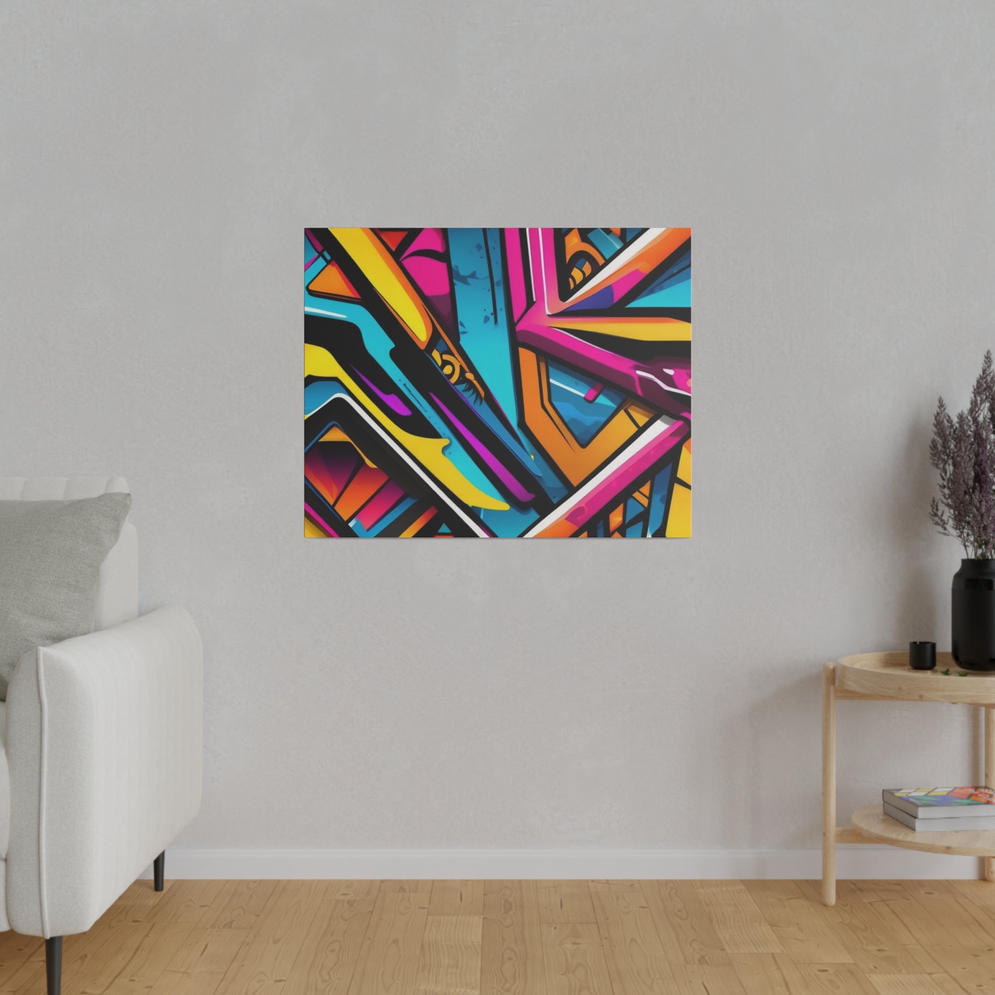 Colorful abstract graffiti artwork in a rectangular frame mounted on a light gray wall.