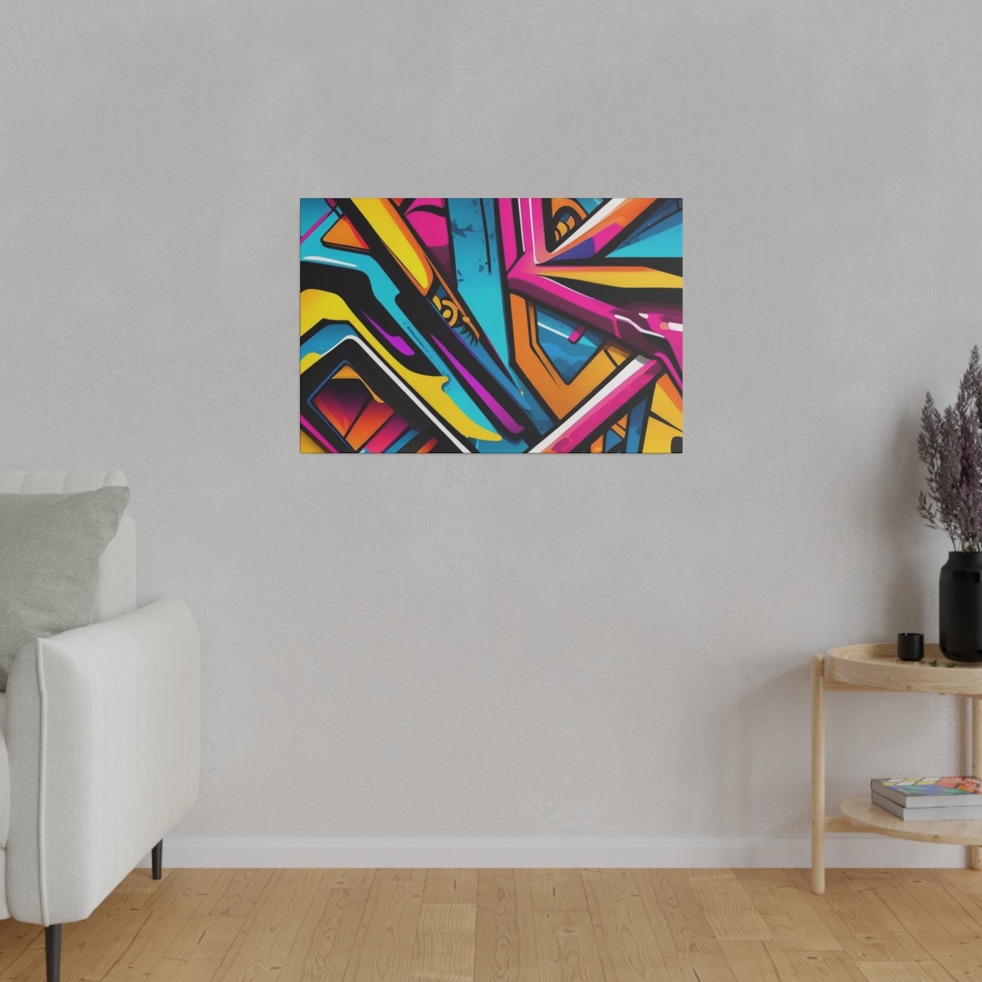 Rectangular abstract painting with bright, multicolored geometric shapes hanging on a gray wall above a wooden floor.