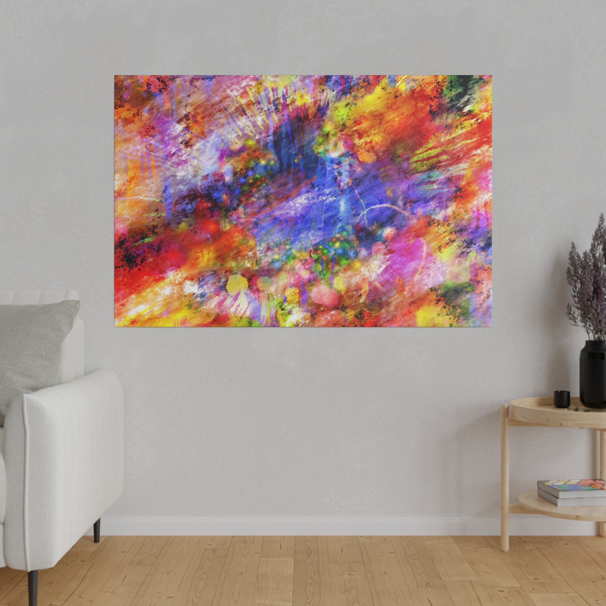 Abstract multicolor painting with red, blue, yellow splashes hanging on a light gray wall in a living room.