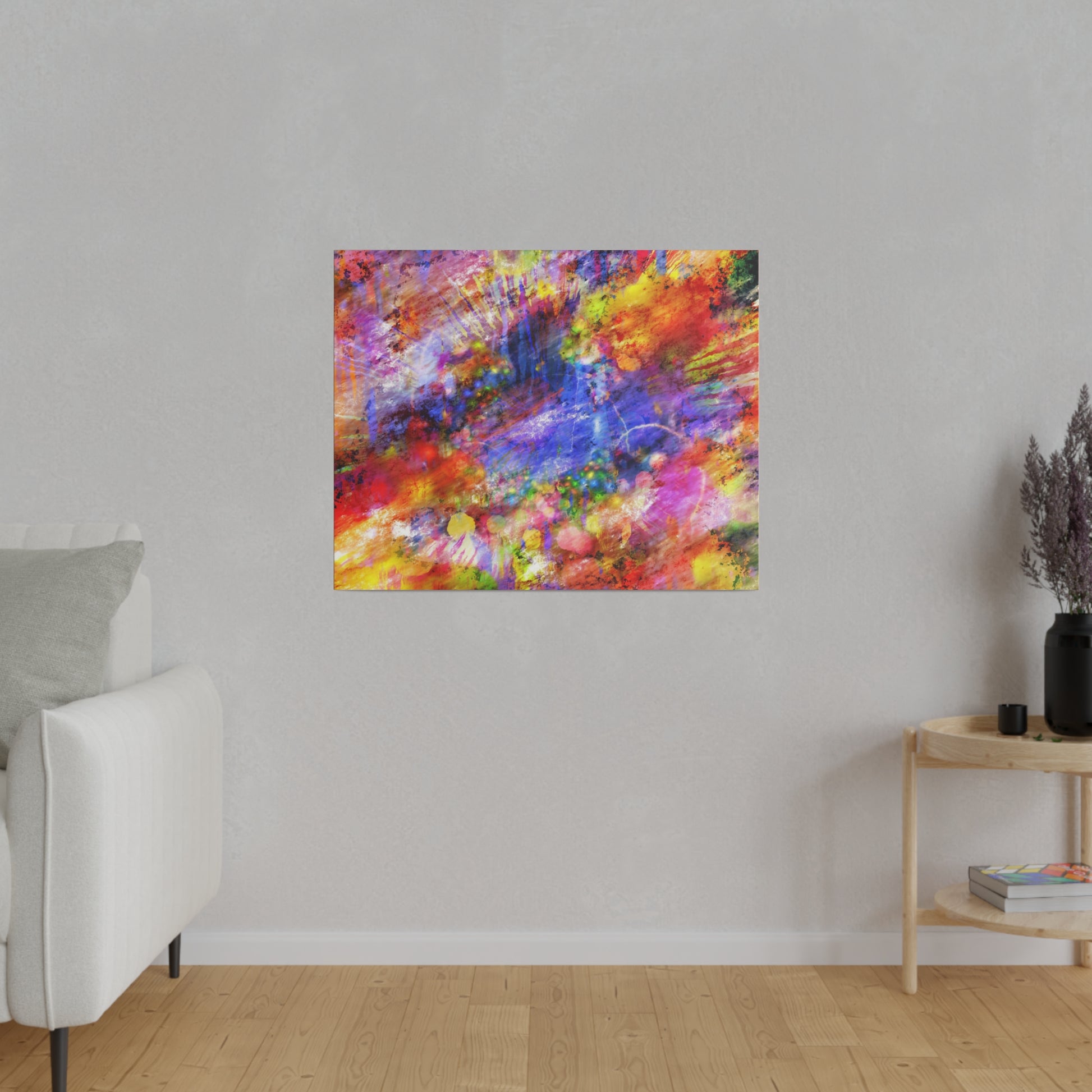Abstract colorful painting with red, blue, yellow splashes hung on a light gray wall in a minimalist living room.