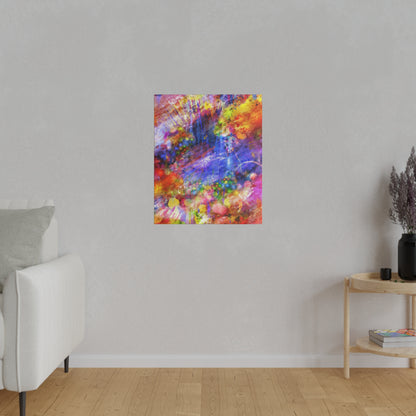 Abstract, multicolor spray-painted canvas hanging on a light gray wall in a minimalist living room.