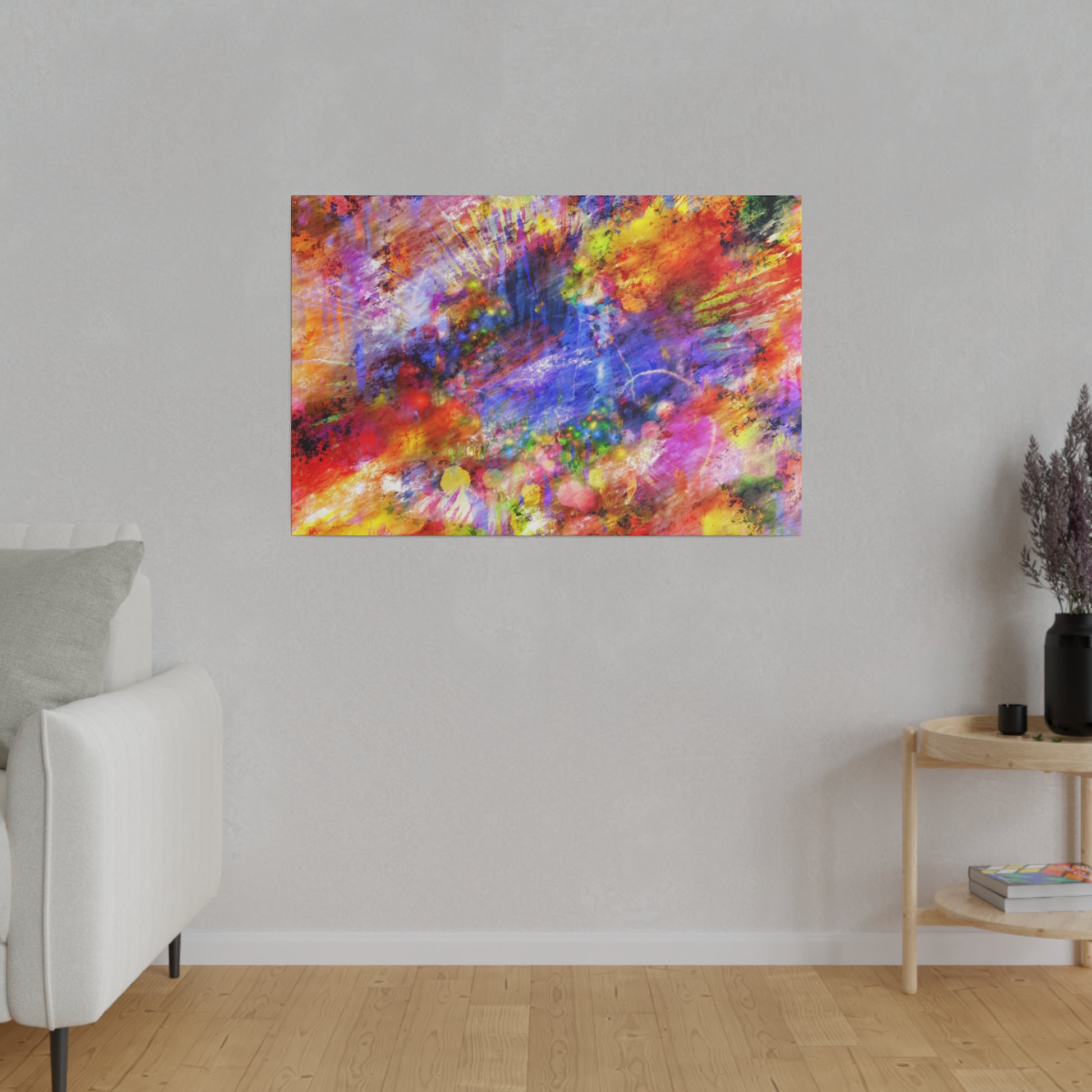Abstract multicolor abstract painting with red, blue, yellow splashes on a light wall above a white sofa.