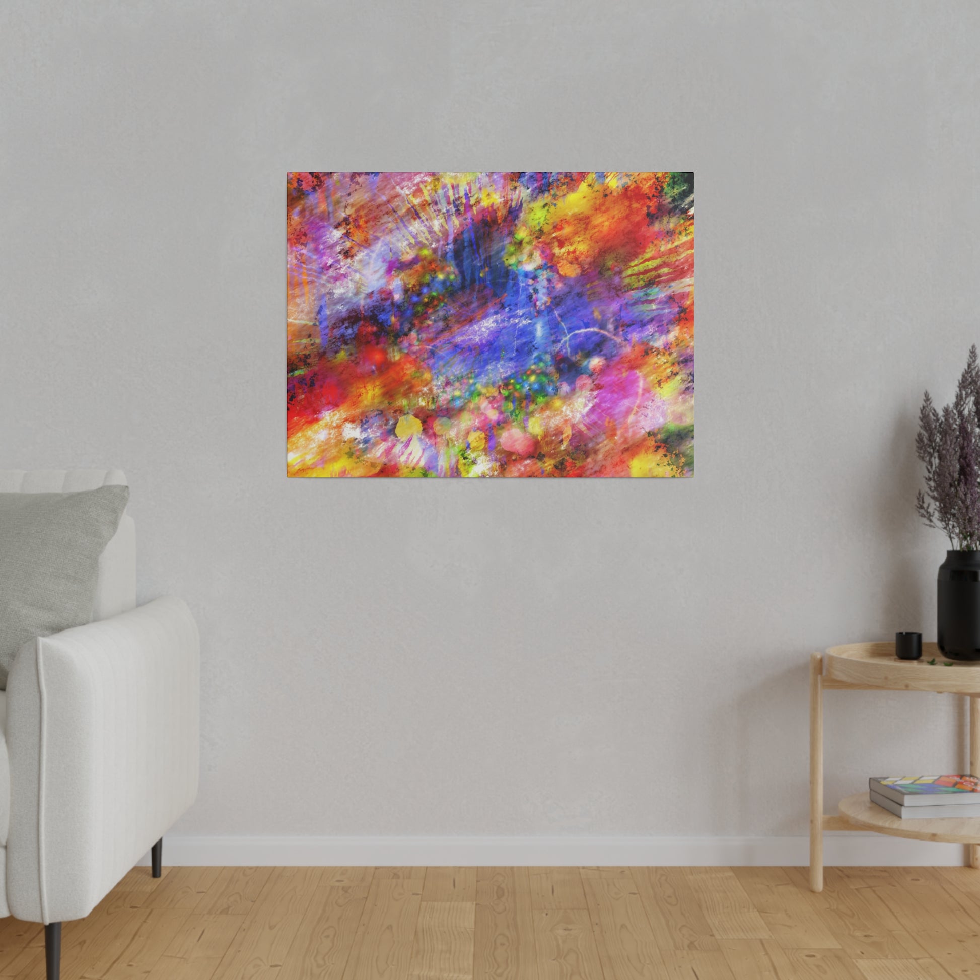 Abstract colorful painting with red, blue, yellow splashes hung on a light gray wall above a wooden floor.