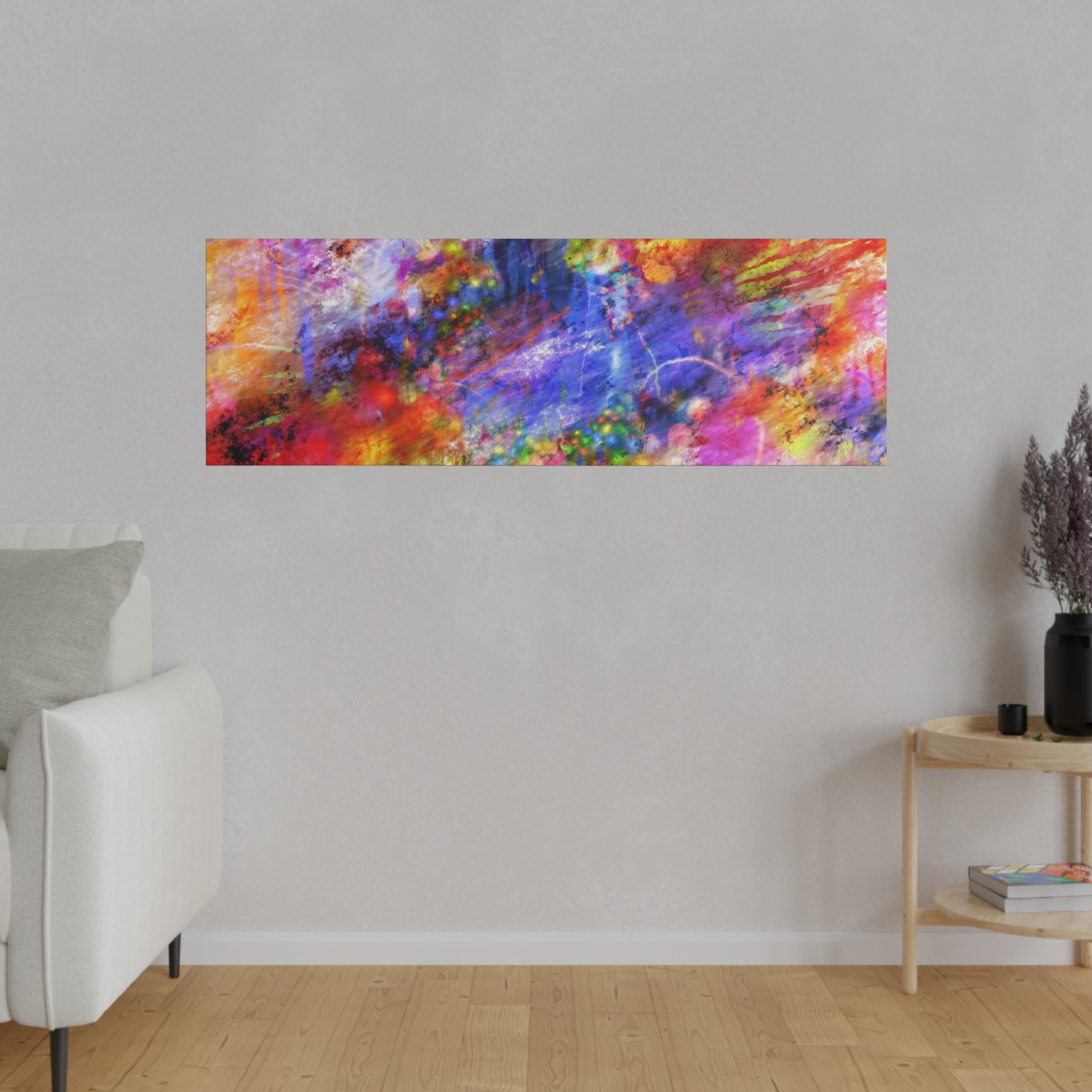 Rectangular abstract painting with vivid colors hangs on a light gray wall above a white sofa and a nearby wooden side table.