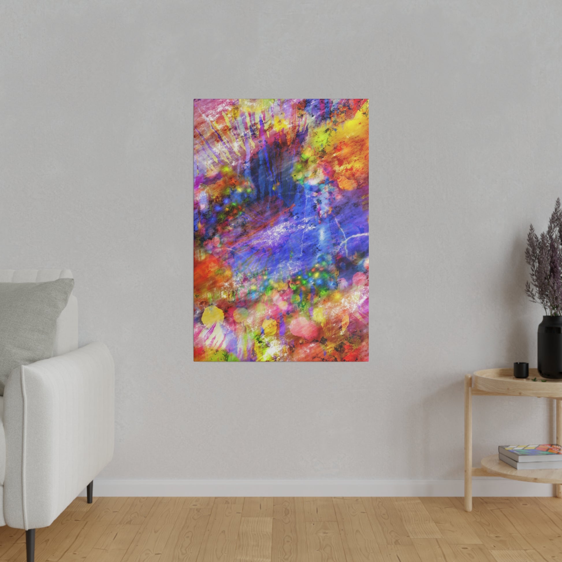Abstract multicolored painting with pink, blue, yellow tones hanging on a light gray wall in a minimalist living room.