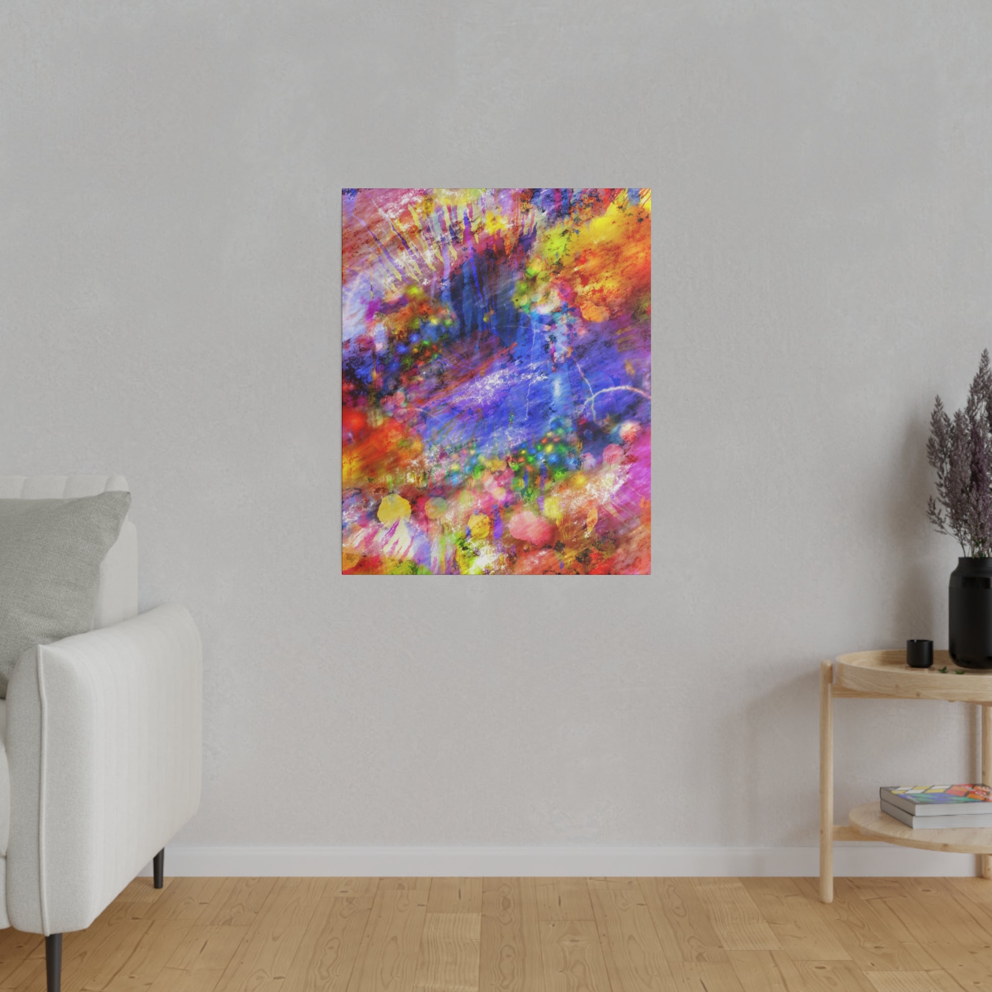Abstract multicolor painting with splashes of red, yellow, blue, and purple hanging on a light gray wall in a minimalist living room.