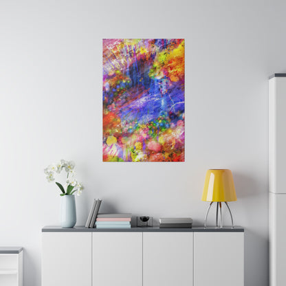 Abstract, multicolored painting mounted on a white wall above a white cabinet with a yellow lampshade and vase of white flowers.
