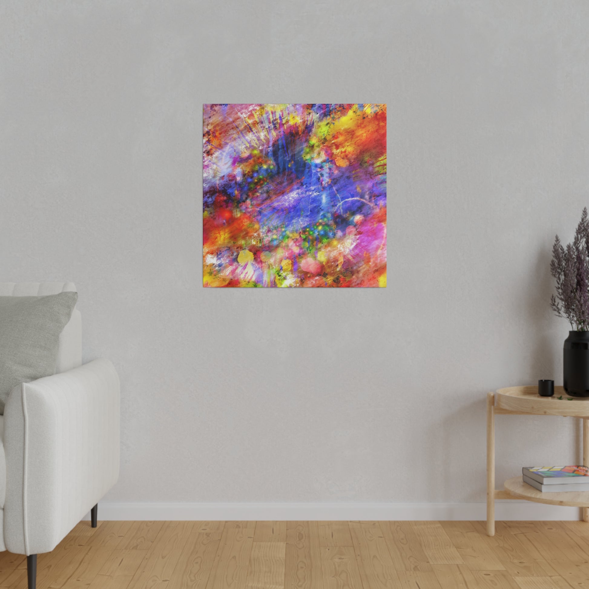 Abstract multicolored square painting mounted on a light gray wall in a minimalist living room.