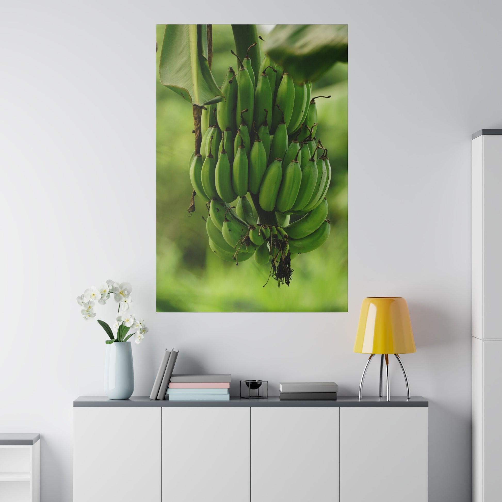 Large wall art poster showing a cluster of green bananas hanging from a plant with a blurred green background.