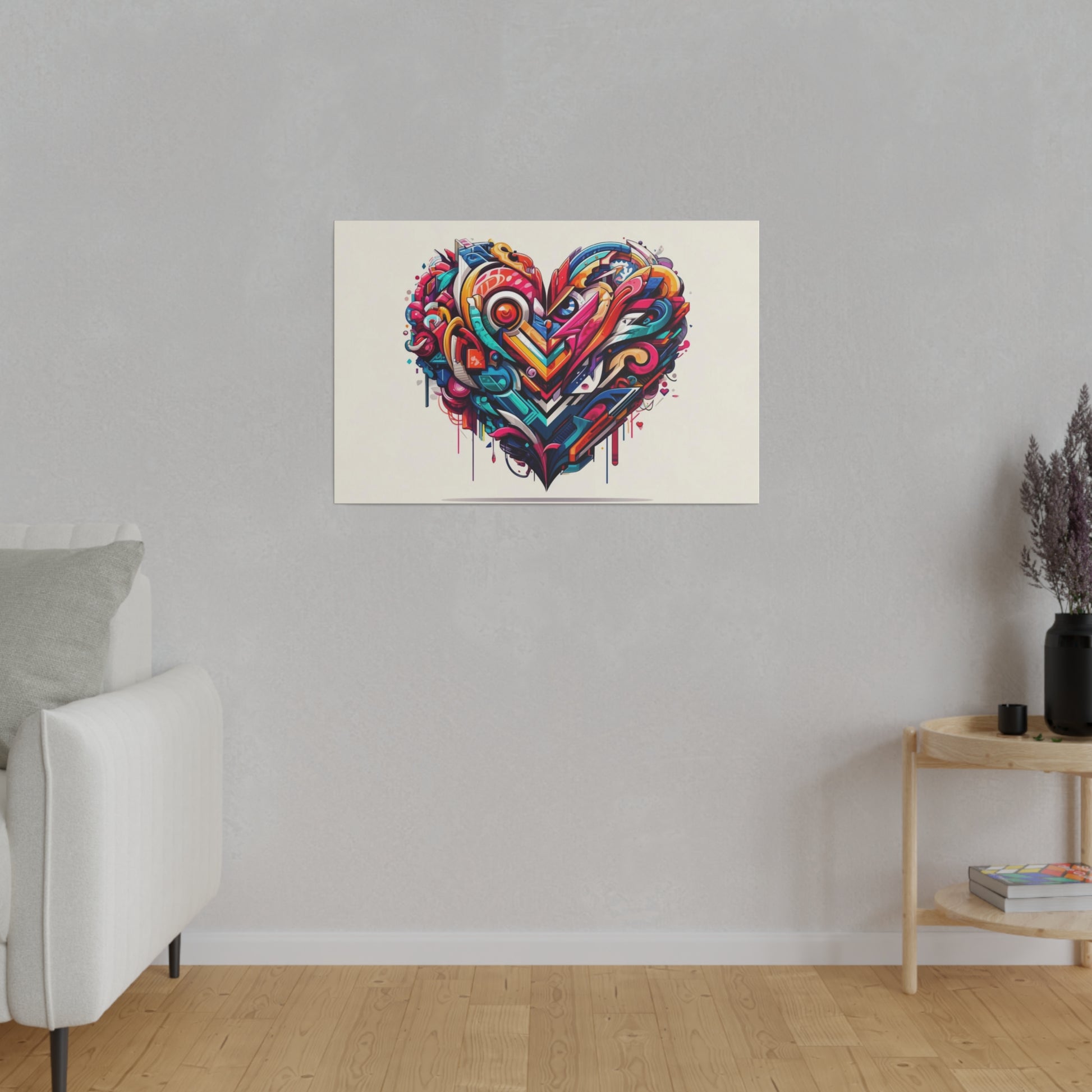 Colorful abstract heart graffiti on a white canvas hanging on a light gray wall in a living room.