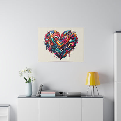 Colorful abstract heart graffiti artwork mounted on a white wall above a white cabinet with a yellow lamp and white flowers.
