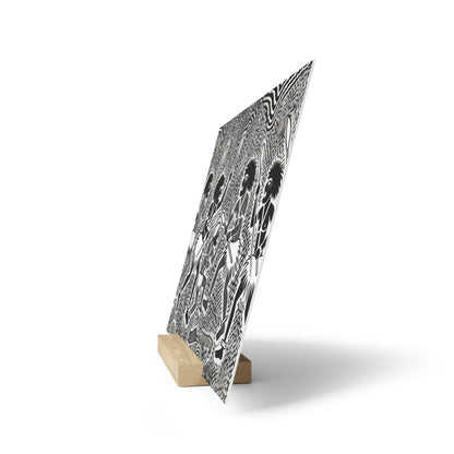 Vertical black-and-white patterned panel mounted on a small wooden stand, tilted at an angle.