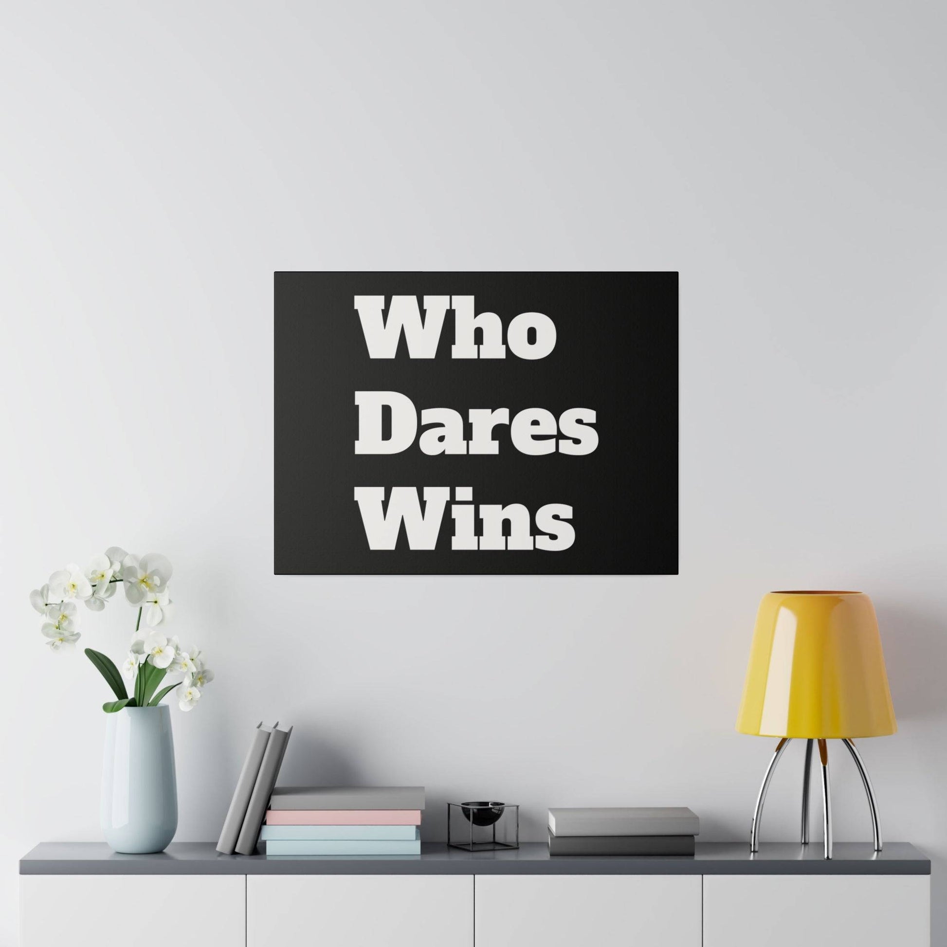 Black poster with bold white text 'Who Dares Wins' hangs above a shelf with a vase and yellow lamp.